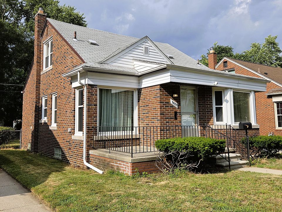 A brick single-family home on a tree-lined Chicago residential street in early evening light.