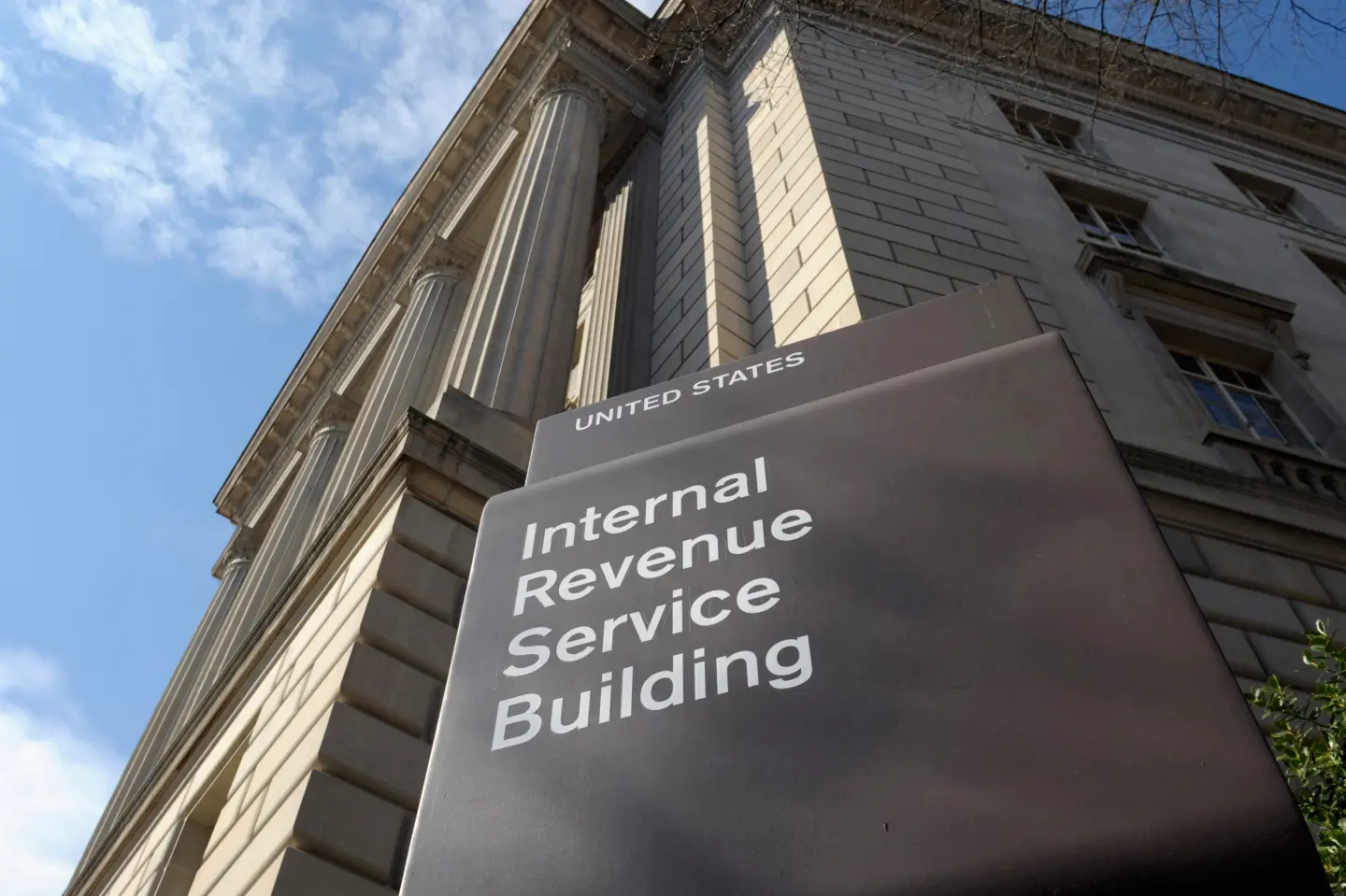The exterior of an Internal Revenue Service building with an American flag near the entrance.